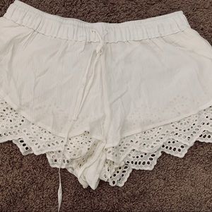 White linen-like shorts with lace detail